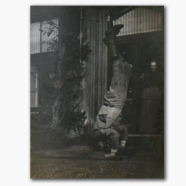 Photograph of Montague Eliot standing on his head (1896), Port Eliot Collection